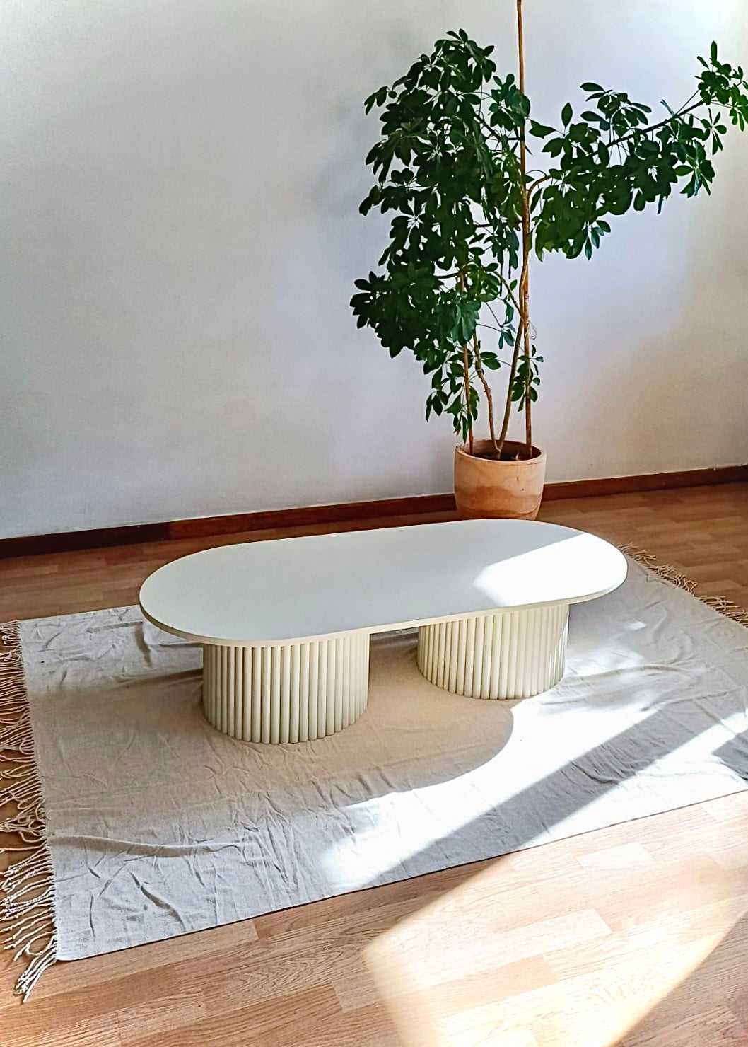 
                  
                    oblong coffee table on 2 fluted bases in light beige
                  
                