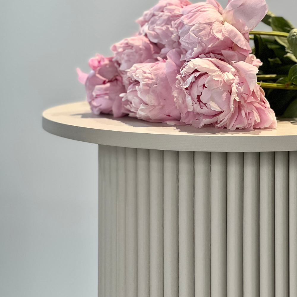 
                  
                    round and fluted bedside table in beige, cafe latte color
                  
                