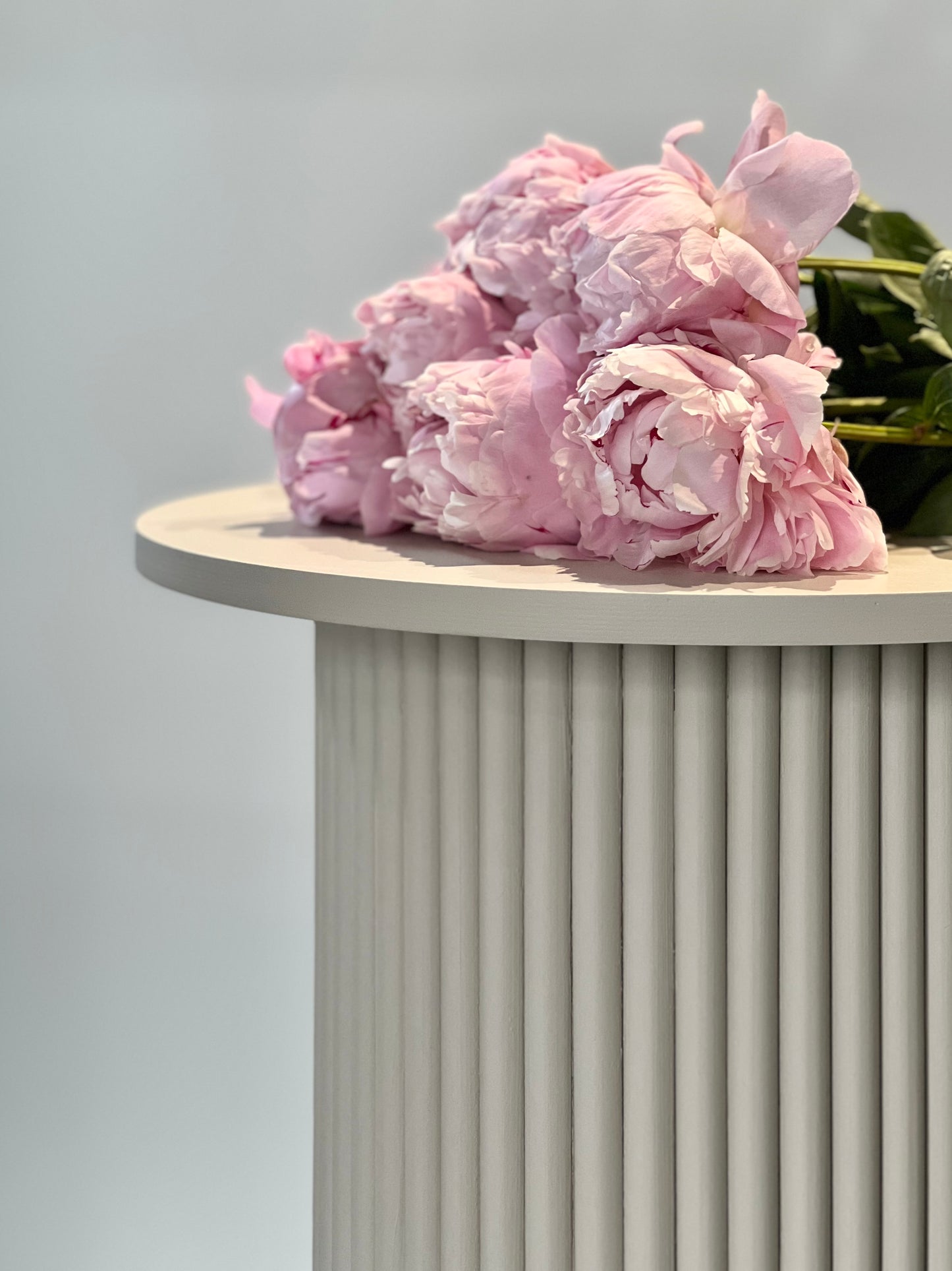 
                  
                    round and fluted bedside table in beige, cafe latte color
                  
                