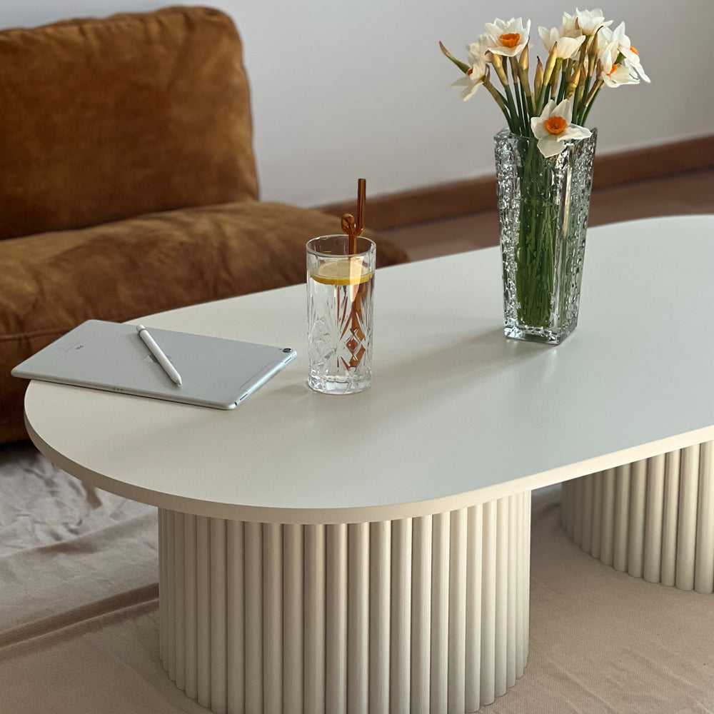 
                  
                    oblong coffee table on 2 fluted bases in light beige
                  
                