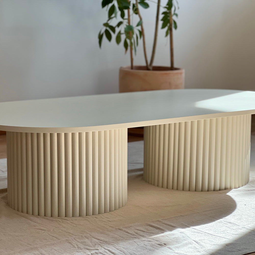 
                  
                    oblong coffee table on 2 fluted bases in light beige
                  
                