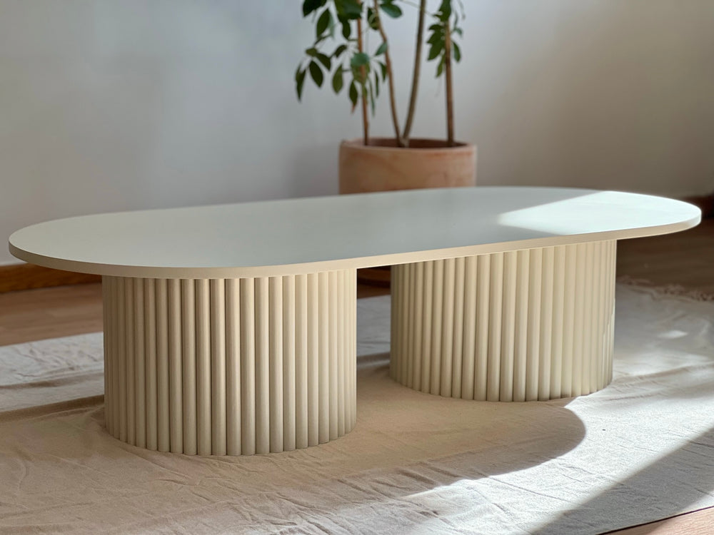 oblong coffee table on 2 fluted bases in light beige