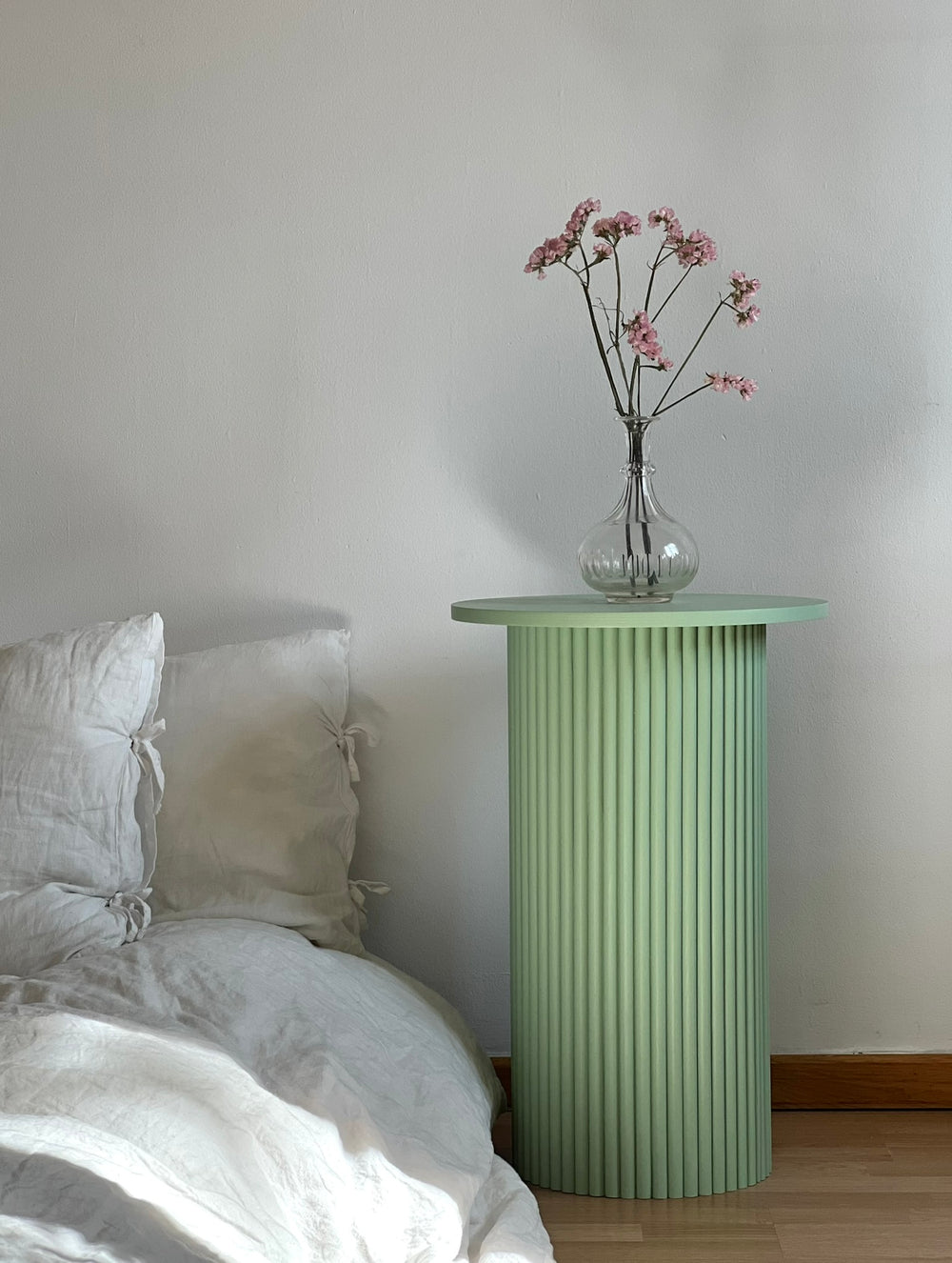 round and fluted bedside table in sage green